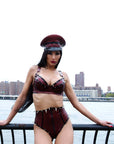 Woman in a latex outfit with a cityscape in the background