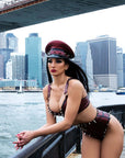 Woman in a latex outfit with a cityscape and bridge in the background