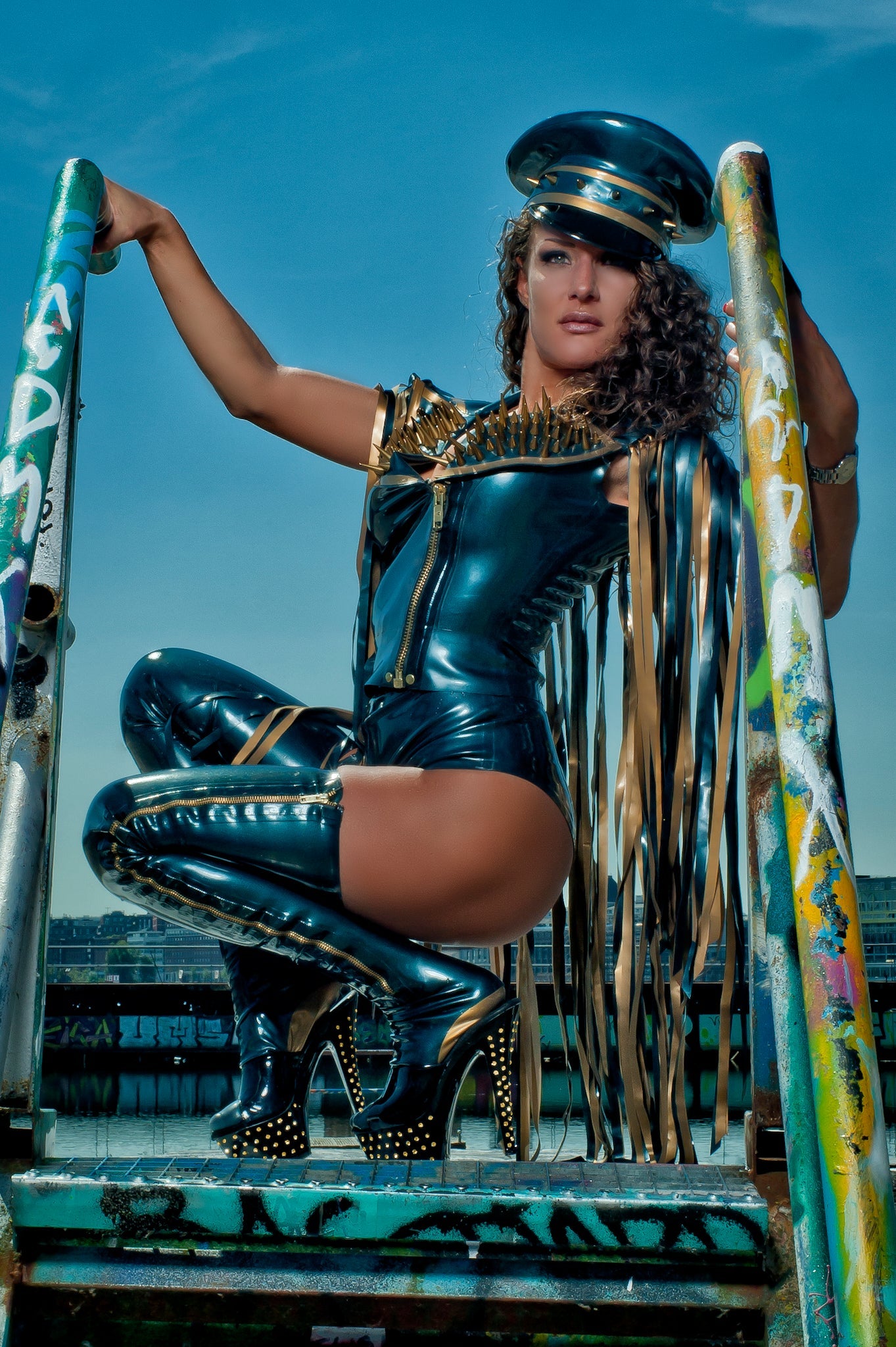 latex Biker sleeveless gilet jacket with fringing and a zip front on a model crouching