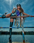 latex Biker sleeveless gilet jacket with fringing and a zip front on a model standing also wearing Latex zip up stockings