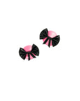 Pair of pink and black bow-shaped pasties on a white background