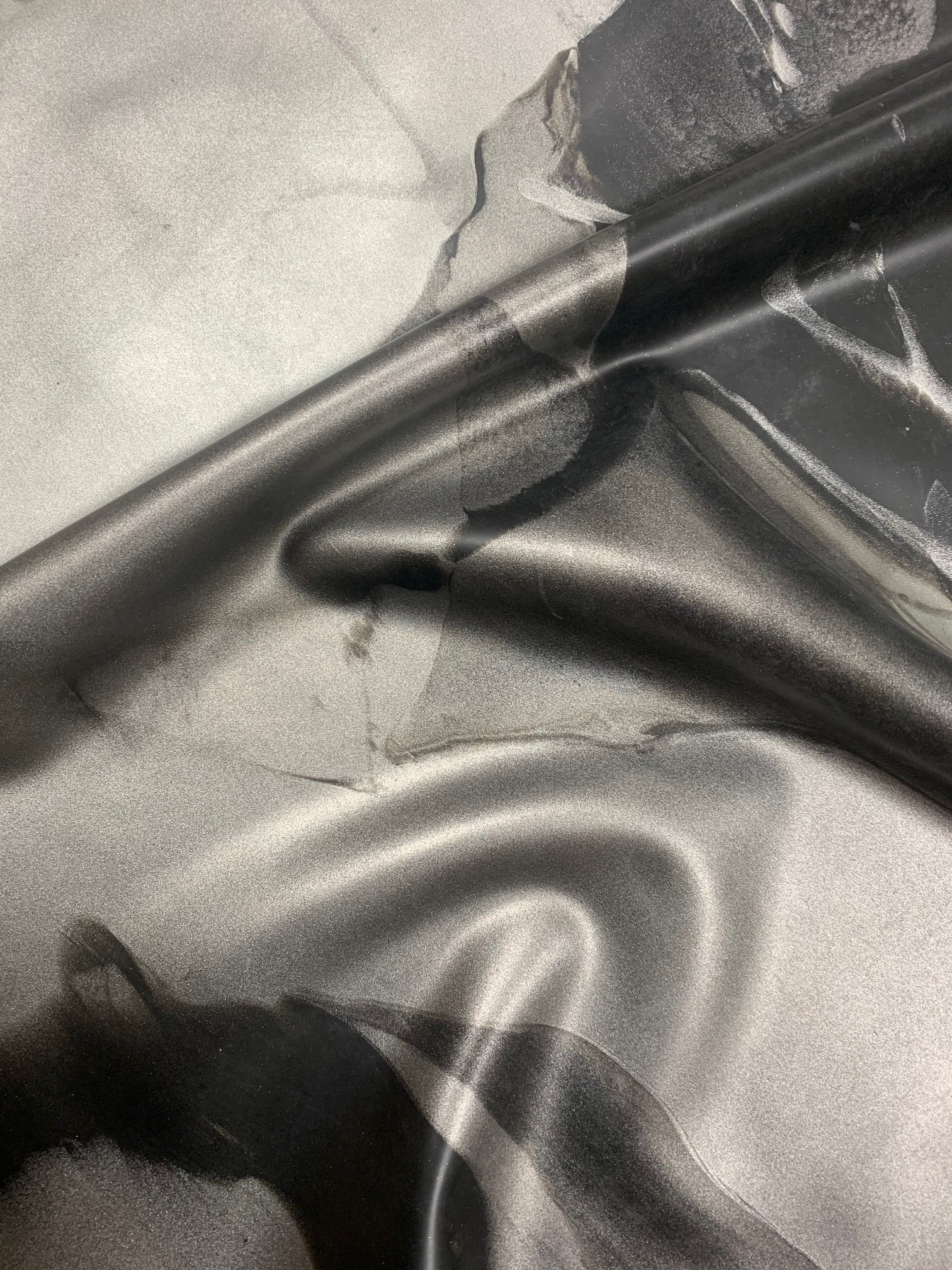 Close-up of a latex marble effect swatch in greys and blacks and silver 